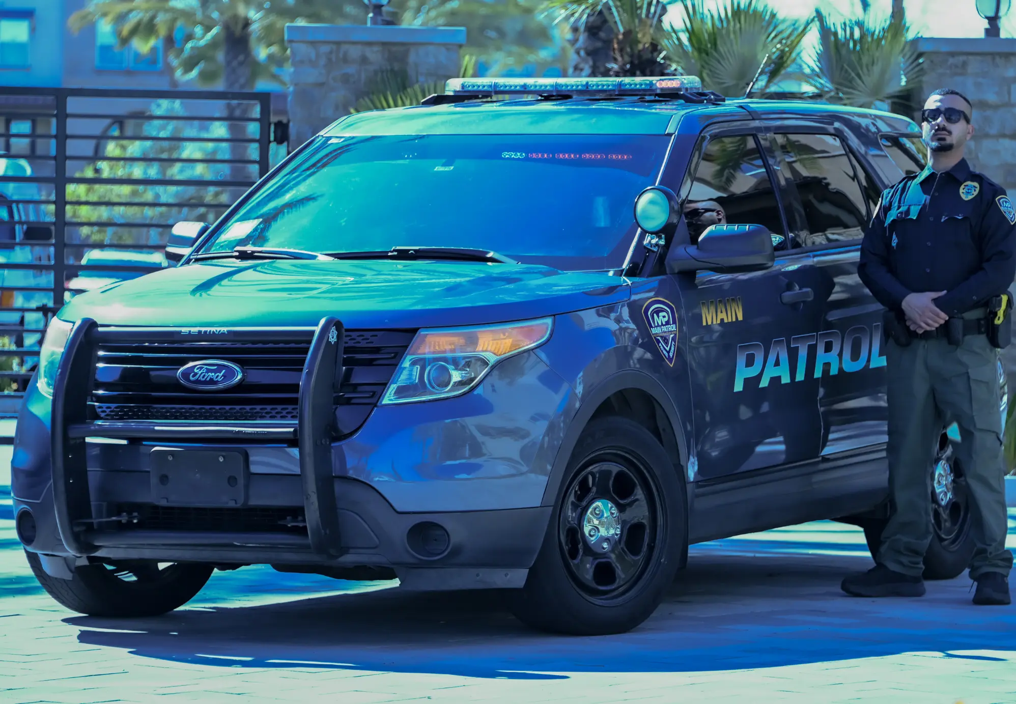 Main Patrol officer beside a Ford Explorer patrol unit